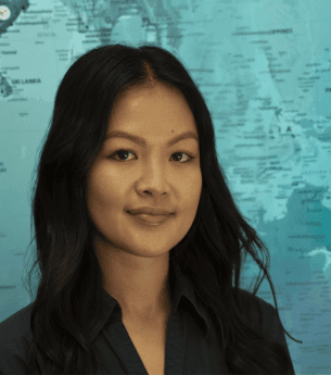 United Franchise Group logo displayed with a professional woman standing in front of a world map, highlighting franchise networking and global business opportunities.